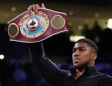 Boxing - Lawrence Okolie v Michal Cieslak - The O2, London, Britain - February 27, 2022 Anthony Joshua holds up Lawrence Okolie's belt before his fight against Michal Cieslak Action Images via Reuters/Andrew Couldridge