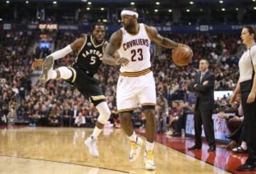 Nov 25, 2015; Toronto, Ontario, CAN; Cleveland Cavaliers forward LeBron James (23) controls the ball as he is guarded by Toronto Raptors forward DeMarre Carroll (5) at Air Canada Centre. The Raptors beat the Cavaliers 103-99. Mandatory Credit: Tom Szczerbowski-USA TODAY Sports