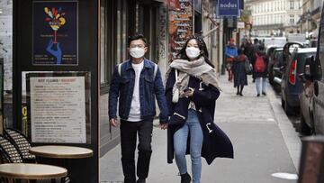 PARIS, FRANCE - MARCH 12: Pedestrians wearing protective masks walk the streets of Paris on March 12, 2020 in Paris, France. Due to a sharp increase in the number of cases of coronavirus (COVID-19) declared in Paris and throughout France, several sporting, cultural and festive events have been postponed or canceled. The epidemic has exceeded 4,600 dead for more than 126,000 infections across ninety-two countries. In France, 2,281 cases and 48 dead are now confirmed. U.S. President, Donald Trump, announced, on Wednesday, March 11, the suspension for thirty days from Friday of all foreigners&#039; trips from Europe to the United States to stem the epidemic due to the coronavirus, which has left 38 dead and more than 1,200 cases of contamination in the United States. The French President, Emmanuel Macron will speak this evening during a televised speech devoted to the coronavirus crisis. (Photo by Chesnot/Getty Images)