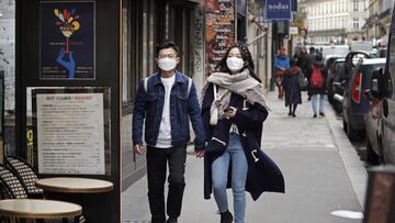 PARIS, FRANCE - MARCH 12: Pedestrians wearing protective masks walk the streets of Paris on March 12, 2020 in Paris, France. Due to a sharp increase in the number of cases of coronavirus (COVID-19) declared in Paris and throughout France, several sporting, cultural and festive events have been postponed or canceled. The epidemic has exceeded 4,600 dead for more than 126,000 infections across ninety-two countries. In France, 2,281 cases and 48 dead are now confirmed. U.S. President, Donald Trump, announced, on Wednesday, March 11, the suspension for thirty days from Friday of all foreigners' trips from Europe to the United States to stem the epidemic due to the coronavirus, which has left 38 dead and more than 1,200 cases of contamination in the United States. The French President, Emmanuel Macron will speak this evening during a televised speech devoted to the coronavirus crisis. (Photo by Chesnot/Getty Images)