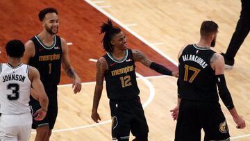 May 19, 2021; Memphis, Tennessee, USA; Memphis Grizzlies guard Ja Morant (12) and forward Kyle Anderson (1) celebrate with Memphis Grizzlies center Jonas Valančiūnas (17) during the forth quarter at FedExForum. Mandatory Credit: Petre Thomas-USA TODAY Sports