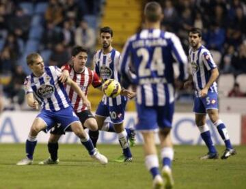 El centrocampista del Athletic Club de Bilbao Unai López disputa un balón con el centrocampista del Deportivo Alex Bergantiños, durante el partido de la decimoséptima jornada de la Liga de Primera División que se juega esta noche en el estadio de Riazor en A Coruña.