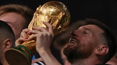 Argentina's captain and forward #10 Lionel Messi lifts the FIFA World Cup Trophy during the trophy ceremony after Argentina won the Qatar 2022 World Cup final football match between Argentina and France at Lusail Stadium in Lusail, north of Doha on December 18, 2022. (Photo by Adrian DENNIS / AFP)