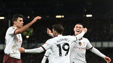 Manchester City's Argentinian striker #19 Julian Alvarez (C) celebrates with teammates after scoring his team second goal during the English Premier League football match between Everton and Manchester City at Goodison Park in Liverpool, north west England on December 27, 2023. (Photo by Paul ELLIS / AFP) / RESTRICTED TO EDITORIAL USE. No use with unauthorized audio, video, data, fixture lists, club/league logos or 'live' services. Online in-match use limited to 120 images. An additional 40 images may be used in extra time. No video emulation. Social media in-match use limited to 120 images. An additional 40 images may be used in extra time. No use in betting publications, games or single club/league/player publications. / 