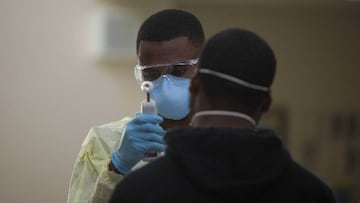 Hospital Corpsman 3rd Class Tavish Davis tests a USS Theodore Roosevelt sailor for symptoms coronavirus disease (COVID-19) at Naval Base Guam April 8, 2020. Picture taken April 8, 2020. U.S. Marine Corps/Staff Sgt. Jordan E. Gilbert/Handout via REUTERS.