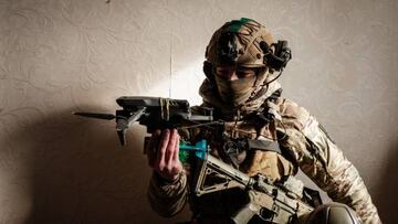 A Ukrainian serviceman of the State Border Guard Service demonstrates a drone with a mimic grenade in Bakhmut on February 9, 2023, amid the Russian invasion of Ukraine. (Photo by YASUYOSHI CHIBA / AFP) (Photo by YASUYOSHI CHIBA/AFP via Getty Images)