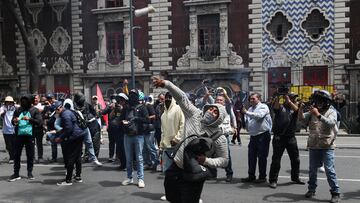 A demonstrator throws a homemade explosive device as demonstrators and relatives of the Mexico's Ayotzinapa students hold a protest ahead of the 10th anniversary of their disappearance, in Mexico City, Mexico September 23, 2024. REUTERS/Henry Romero