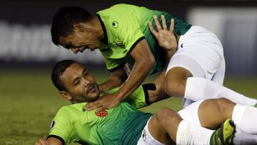 Juan Manuel Falcon, bottom, and teammate Ricardo Clarke of Venezuela's Zamora celebrate after Falcon scored during a Copa Libertadores soccer game against Paraguay's Guarani in Asuncion, Paraguay, Wednesday, April 12, 2017.(AP Photo/Jorge Saenz)