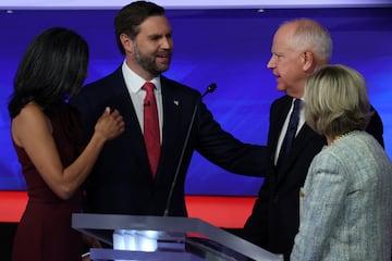 Democratic Minnesota Governor Tim Walz and his wife Gwen and Republican US Senator JD Vance and his wife Usha Chilukuri Vance stand onstage at the end of a debate hosted by CBS in New York