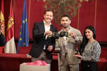 (I-D) El alcalde de Toledo, Carlos Velázquez; el actual campeón del mundo de peso pluma de la UFC, Ilia Topuria y su pareja Giorgina Uzcategui, durante una reunión en el Despacho de Alcaldía.