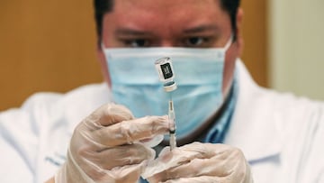 Walgreens healthcare professional Luis S. Solano prepares a dose of the Pfizer-BioNTec vaccine at the Victor Walchirk Apartments in Evanston, Illinois.