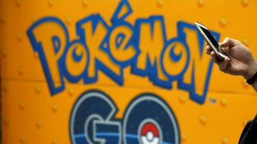 A man uses a mobile phone in front of an advertisement board bearing the image of Pokemon Go at an electronic shop in Tokyo, Japan, July 27, 2016. REUTERS/Kim Kyung-Hoon/File Photo