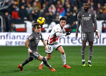 Soccer Football - LaLiga - Rayo Vallecano v Real Madrid - Campo de Futbol de Vallecas, Madrid, Spain - December 14, 2024 Real Madrid's Fran Garcia in action with Rayo Vallecano's Sergio Camello REUTERS/Susana Vera