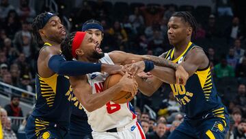 Dec 10, 2022; Indianapolis, Indiana, USA; Brooklyn Nets guard Patty Mills (8) ties up the ball against Indiana Pacers guard Buddy Hield (24) and guard Bennedict Mathurin (00) in the second half at Gainbridge Fieldhouse. Mandatory Credit: Trevor Ruszkowski-USA TODAY Sports