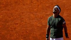 Italian tennis player Fabio Fognini looks upwards during his match against Spanish player Rafael Nadal during the ATP Madrid Open in Madrid, on May 10, 2017. / AFP PHOTO / OSCAR DEL POZO