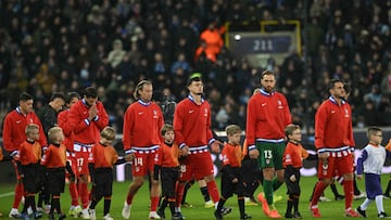 Atletico Madrid's players enter the pitch before the start of the UEFA Champions League knockout round play-off first leg football match between Club Brugge and Atletico Madrid at the Jan Breydel Stadium in Brugge on February 18, 2026. (Photo by NICOLAS TUCAT / AFP)