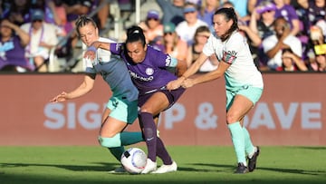 Nov 17, 2024; Orlando, FL, USA; Orlando Pride forward Marta (10) battles for the ball with Kansas City Current midfielder Claire Hutton (14) and Kansas City Current midfielder Vanessa DiBernardo (16) in a NWSL playoff semifinal match at Inter&Co Stadium. Mandatory Credit: Mike Watters-Imagn Images