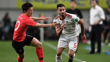 South Korea's Lee Jae-sung (L) fights for the ball with Iran's Milad Mohammadi (R) during a friendly football match in Seoul on June 11, 2019. (Photo by Jung Yeon-je / AFP)
