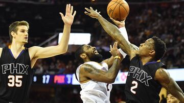 Jan 19, 2017; Cleveland, OH, USA; Cleveland Cavaliers guard Kyrie Irving (2) drives to the basket between Phoenix Suns forward Dragan Bender (35) and guard Eric Bledsoe (2) during the first half at Quicken Loans Arena. Mandatory Credit: Ken Blaze-USA TODAY Sports