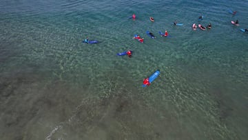 A drone view shows surfers dressed as Santa Claus on the Mediterranean Sea, in Tel Aviv, Israel December 2, 2025. REUTERS/Ammar Awad