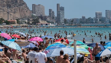 ALICANTE, SPAIN - 2024/07/14: Tourists and locals cool off swimming and sunbathing at a crowded El Postiguet Beach during a summer day. The Tourism Ministry has predicted that 41 million international tourists are expected to visit Spain this summer setting a new record. (Photo by Marcos del Mazo/LightRocket via Getty Images)