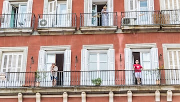 Madrid, Spain - May, 15, 2014:Several neighbors poke their balconies to watch the procession of San Isidro in the area of old Madrid