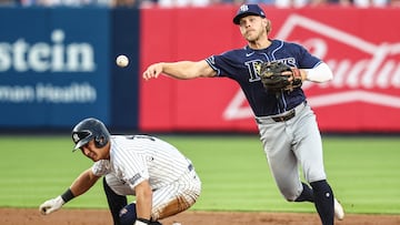 Jul 19, 2024; Bronx, New York, USA; Tampa Bay Rays shortstop Taylor Walls (6) throws past New York Yankees shortstop Anthony Volpe (11) to complete a double play in the second inning at Yankee Stadium. Mandatory Credit: Wendell Cruz-USA TODAY Sports