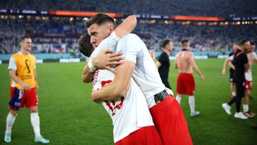 DOHA, QATAR - NOVEMBER 30: Bartosz Bereszynski and Krystian Bielik of Poland celebrate after their sides qualification to the knockout stages during the FIFA World Cup Qatar 2022 Group C match between Poland and Argentina at Stadium 974 on November 30, 2022 in Doha, Qatar. (Photo by Adam Pretty - FIFA/FIFA via Getty Images)