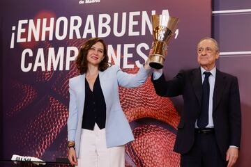 La presidenta de la Comunidad de Madrid, Isabel Díaz Ayuso, alza la copa de campeones de la Euroliga junto al presidente del Real Madrid, Florentino Pérez, durante la recepción al Real Madrid de baloncesto por proclamarse campeón de la Euroliga.