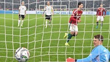 Hungary's midfielder #10 Dominik Szoboszlai scores the 1-1 goal from the penalty spot past Germany's goalkeeper #12 Alexander Nuebel during the UEFA Nations League Group A3 football match Hungary vs Germany at the Puskas Arena in Budapest, Hungary, on November 19, 2024. (Photo by Attila KISBENEDEK / AFP)