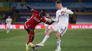 LEEDS, ENGLAND - APRIL 19: Sadio Mane of Liverpool is challenged by Diego Llorente of Leeds United during the Premier League match between Leeds United and Liverpool at Elland Road on April 19, 2021 in Leeds, England. Sporting stadiums around the UK remai