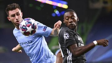 Manchester City's Aymeric Laporte, left, and Lyon's Karl Toko Ekambi battle for the ball during the Champions League quarterfinal match between Manchester City and Lyon at the Jose Alvalade stadium in Lisbon, Portugal, Saturday, Aug. 15, 2020. (