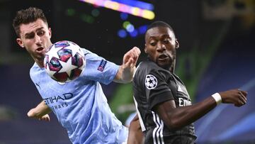 Manchester City&#039;s Aymeric Laporte, left, and Lyon&#039;s Karl Toko Ekambi battle for the ball during the Champions League quarterfinal match between Manchester City and Lyon at the Jose Alvalade stadium in Lisbon, Portugal, Saturday, Aug. 15, 2020. (