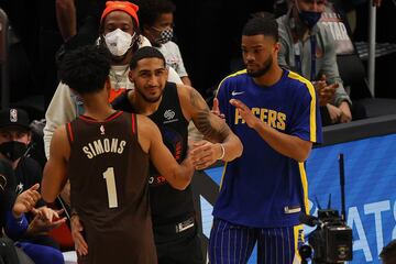 Anfernee Simons of the Portland Trail Blazers, Obi Toppin of the New York Knicks and Cassius Stanley of the Indiana Pacers embrace following the 2021 NBA All-Star - AT&T Slam Dunk Contest during All-Star Sunday Night at State Farm Arena.