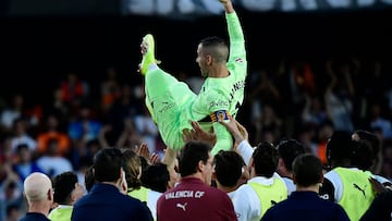 Valencia's Spanish goalkeeper #01 Jaume Domenech is lifted by his teammates at the end of the Spanish league football match between Valencia CF and Athletic Club Bilbao at Mestalla Stadium in Valencia on May 18, 2025. (Photo by JOSE JORDAN / AFP)
