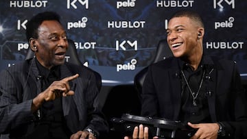 Paris Saint-Germain (PSG) and France national football team forward Kylian Mbappe (R) and Brazilian football legend Pele (L) speak as they take part in a meeting at the Hotel Lutetia in Paris on April 2, 2019. (Photo by FRANCK FIFE / AFP)