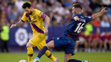 VALENCIA, SPAIN - NOVEMBER 02: Ruben Rochina of Levante UD tackles Lionel Messi of FC Barcelona during the Liga match between Levante UD and FC Barcelona at Ciutat de Valencia on November 02, 2019 in Valencia, Spain. (Photo by Alex Caparros/Getty Images)