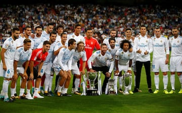 The Real Madrid players pose with the LaLiga, Spanish Super Cup and UEFA Super Cup trophies.