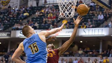 Mar 24, 2017; Indianapolis, IN, USA; Indiana Pacers center Myles Turner (33) shoots the ball while Denver Nuggets forward Nikola Jokic (15) fouls him in the second half of the game at Bankers Life Fieldhouse. The Denver Nuggets beat the Indiana Pacers 125-117. Mandatory Credit: Trevor Ruszkowski-USA TODAY Sports