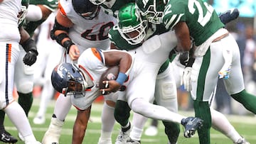 EAST RUTHERFORD, NEW JERSEY - SEPTEMBER 29: Tyler Badie (28) of the Denver Broncos is tackled by the New York Jets during the second quarter at MetLife Stadium on September 29, 2024 in East Rutherford, New Jersey. Mike Stobe/Getty Images/AFP (Photo by Mike Stobe / GETTY IMAGES NORTH AMERICA / Getty Images via AFP)