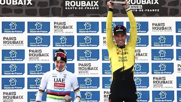 Winner Team Visma - Lease a Bike's Belgian rider Wout van Aert celebrates next to second placed UAE Team Emirates XRG's Slovenian rider Tadej Pogacar (L) on the podium of the 123rd edition of the Paris-Roubaix one-day classic cycling race, 258.3 km between Compi�gne and Roubaix, at the V�lodrome Andr�-P�trieux in Roubaix, northern France, on April 12, 2026. (Photo by Anne-Christine POUJOULAT / AFP)