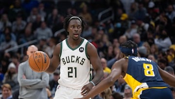 Nov 28, 2021; Indianapolis, Indiana, USA; Milwaukee Bucks guard Jrue Holiday (21) dribbles the ball while Indiana Pacers forward Justin Holiday (8) defends  in the second half at Gainbridge Fieldhouse. Mandatory Credit: Trevor Ruszkowski-USA TODAY Sports