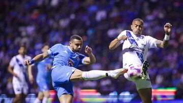 Giorgos Giakoumakis (L) of Cruz Azul fights for the ball with Emanuel Gularte (R) of Puebla  during the 12th round match between Puebla and Cruz Azul as part of the Liga BBVA MX, Torneo Apertura 2024 at Cuauhtemoc Stadium on October 18, 2024 in Puebla, Mexico.