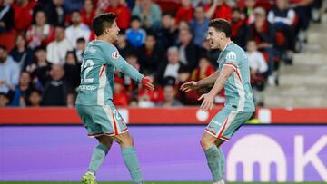 Atletico Madrid's Argentinian forward #19 Julian Alvarez (R) celebrates scoring the opening goal, with Atletico Madrid's Argentinian forward #22 Giuliano Simeone, during the Spanish league football match between RCD Mallorca and Club Atletico de Madrid at the Mallorca Son Moix stadium in Palma de Mallorca on November 10, 2024. (Photo by JAIME REINA / AFP)