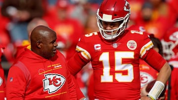 KANSAS CITY, MISSOURI - JANUARY 30: Quarterback Patrick Mahomes #15 of the Kansas City Chiefs talks with offensive coordinator Eric Bieniemy during the AFC Championship Game against the Cincinnati Bengals at Arrowhead Stadium on January 30, 2022 in Kansas