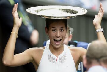 Garbine Muguruza of Spain celebrates with her trophy after winning against Venus Williams of the USA during their final match for the Wimbledon Championships at the All England Lawn Tennis Club, in London, Britain, 15 July 2017.