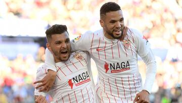 Sevilla's Mexican forward Jesus Manuel Corona aka Tecatito (L) celebrates with Sevilla's Moroccan forward Youssef En-Nesyri after scoring his team's second goal during the Spanish League football match between Levante UD and Sevilla FC at t
