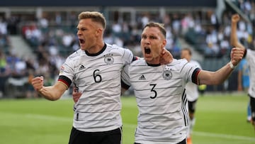 MOENCHENGLADBACH, GERMANY - JUNE 14: Joshua Kimmich of Germany celebrates scoring their side's first goal with teammates David Raum during the UEFA Nations League League A Group 3 match between Germany and Italy at Borussia Park Stadium on June 14, 2022 in Moenchengladbach, Germany. (Photo by Martin Rose/Getty Images)