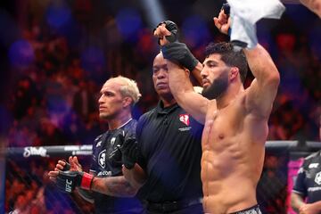 Apr 13, 2024; Las Vegas, Nevada, USA; Arman Tsarukyan (blue gloves) reacts after defeating Charles Oliveira (red gloves) during UFC 300 at T-Mobile Arena. Mandatory Credit: Mark J. Rebilas-USA TODAY Sports