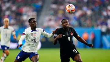 Jun 18, 2023; Las Vegas, Nevada, USA; Canada defender Kamal Miller (4) and USA forward Folarin Balogun (20) battle for the ball against during the first half at Allegiant Stadium. Mandatory Credit: Lucas Peltier-USA TODAY Sports